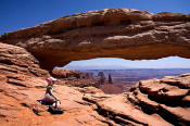 Image of Girl hiker and Mesa Arch, Canyonlands National Park, Utah, southwest