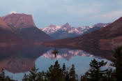 Image of St. May Lake reflection at dawn from Wild Goose Island in Glacier.